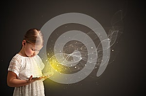 Little kid playing on sparkling tablet