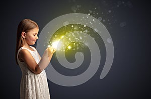 Little kid playing on sparkling tablet
