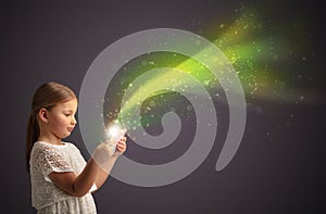 Little kid playing on sparkling tablet photo