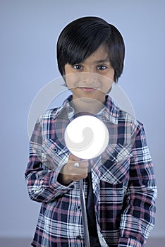 Little kid portrait holding lamp light