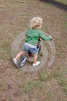 Little kid riding his bike down