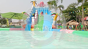 Little kid swimming in pool, relaxing in the swiming pool in a summer hot day. refershing in holiday, a pink float enjoying the