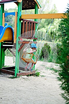 Little kid on a swing