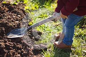 Little kid working in the garden.