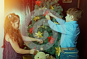 little kids decorate Christmas tree