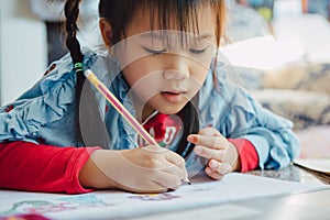 Little kids drawing cartoon with color pencil that is good activity for improve creative art and hand writing skills