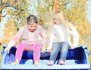 Little kids - girls looking in to container