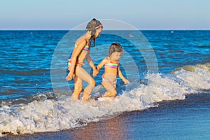 Little kids go to swim in sea