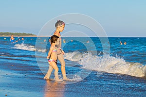 Little kids go to swim in sea water