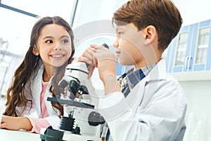 Little kids learning chemistry in school laboratory communication