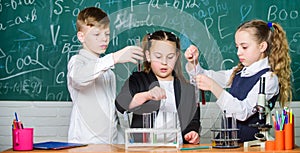 Little kids learning chemistry in school laboratory. students doing biology experiments with microscope in lab. Biology