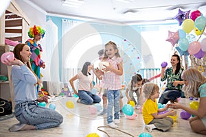 Little kids and parents have fun on children birthday party