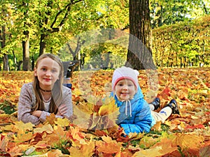 Little kids playing in autumn park. Children in park