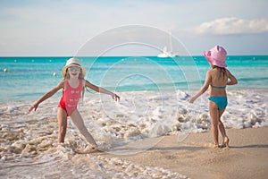 Little kids playing in shallow water at exotic