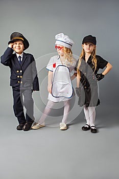 The little kids pose in the costumes of different profession