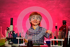Little kids scientist earning chemistry in school lab. Science. Happy little scientist making experiment with test tube
