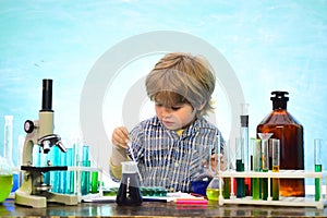Little kids scientist earning chemistry in school lab. What is taught in chemistry. Lab microscope and testing tubes