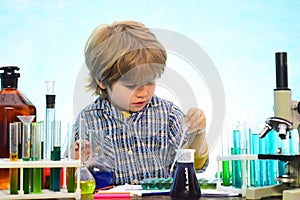 Little kids scientist earning chemistry in school lab. What is taught in chemistry. Lab microscope and testing tubes