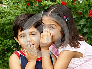 Little kids telling secrets photo