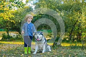Little kids walking together with their pet dog outdoors. Love kids concept. Little Boy playing with his dog outdoors