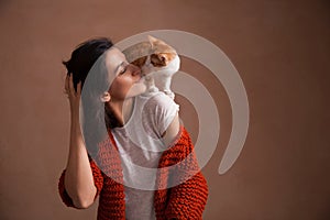 Little kitten on woman shoulder