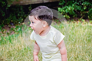 Little latin boy shouting outdoors.