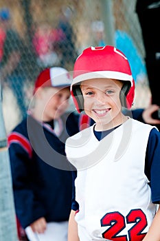 Little league baseball boy in dugout