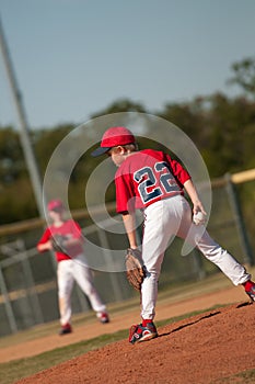 Little league baseball pitcher looking at batter.