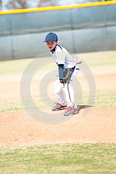 Little league pitcher starting his wind up.
