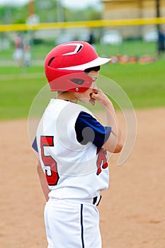 Little league player on base.