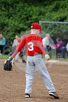 Little League player waiting for action