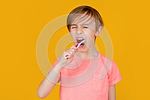 Little man brushing teeth. Happy child kid boy with toothbrush. Health care, dental hygiene. Little boy cleaning teeth