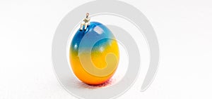 A little man is sitting on a Easter Egg