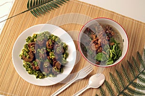 Little meatballs with green chili sauce in a plate and gravy in a bowl