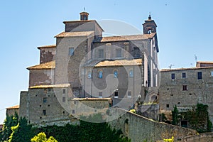 Little medieval town skyline of Grotte di Castro, Lazio, Italy, with blue sky in background