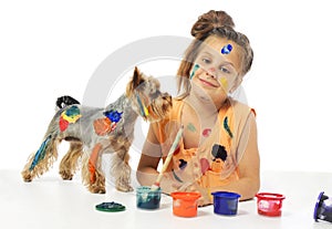 Little messy girl painter with dog