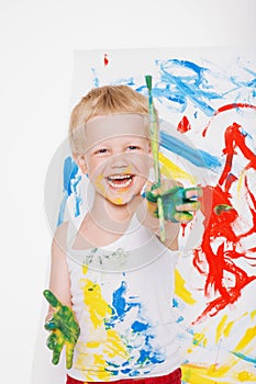 Little messy kid painting with paintbrush picture on easel. Education. Creativity. School. Preschool. Studio portrait over white