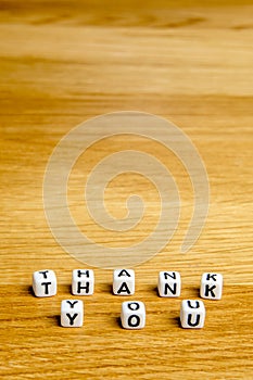 Little miniature figurines with little dices forming word thank you as a part of team meeting collection pictures