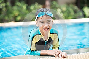 Little mix Asian Arab boy swimming at swimming pool outdoor activity