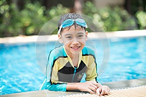 Little mix Asian Arab boy swimming at swimming pool outdoor activity photo