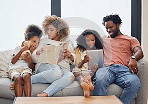 Little moments make big memories. a young family spending time together and using a digital tablet at home.