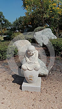 Little monk statues in the garden with different poses cute and believable