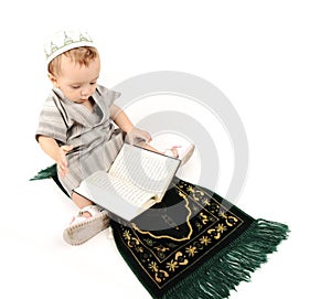 Little muslim kid is praying photo