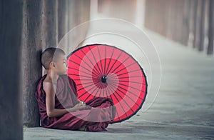 Little Myanmar monk sitting in monastery