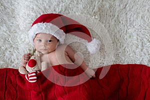 Little newborn baby boy, wearing Santa hat
