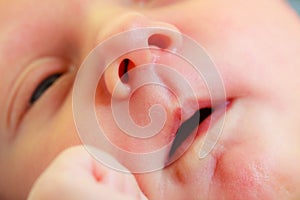 Little newborn baby face closeup