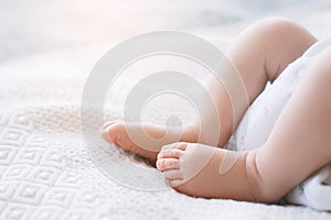 Little newborn baby feet white background