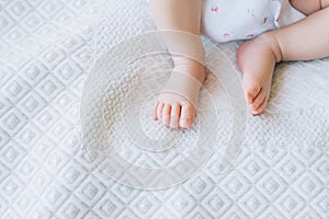 Little newborn baby feet on white background
