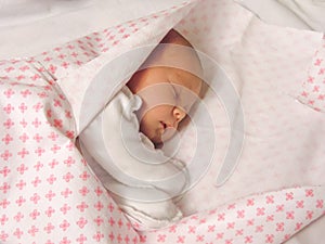 Little newborn baby girl sleeping in a sweet sleep.