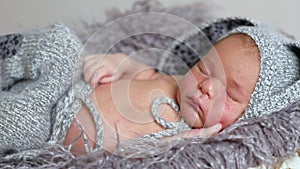 Little newborn baby sleeping among blankets